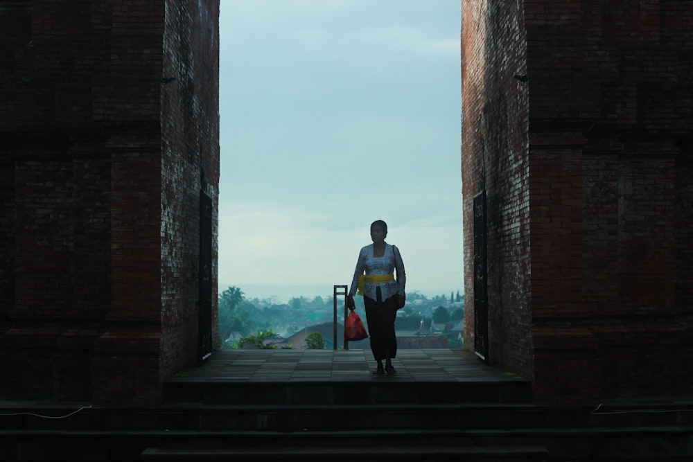 man in black jacket walking on the stairs