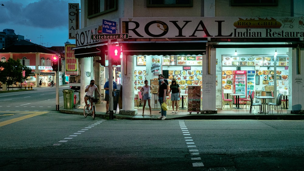 people walking on sidewalk near store during daytime