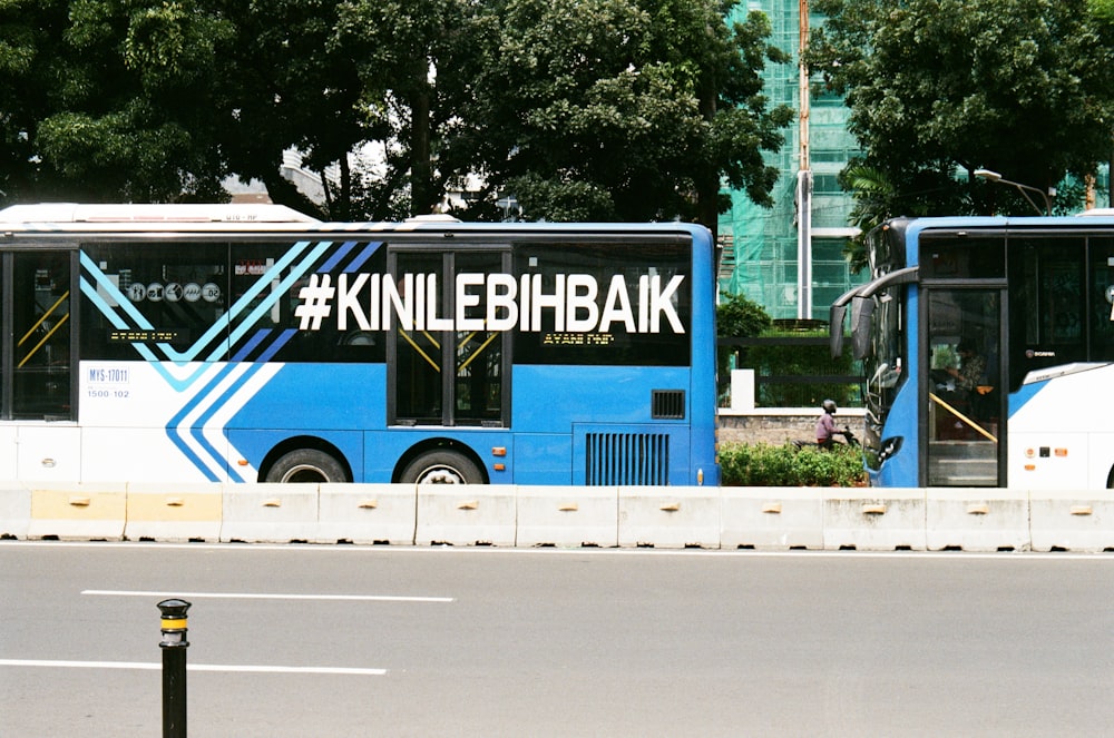 a couple of buses parked next to each other on a street