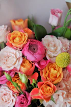pink and yellow roses in white ceramic vase