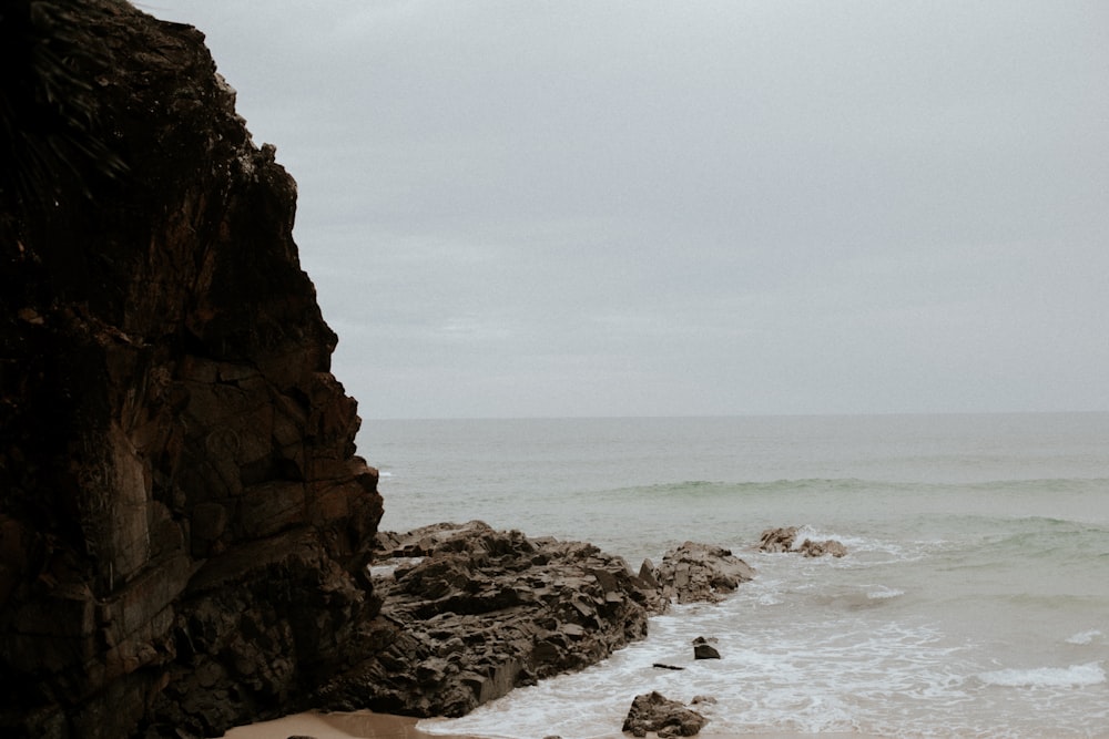 brown rock formation on sea water during daytime