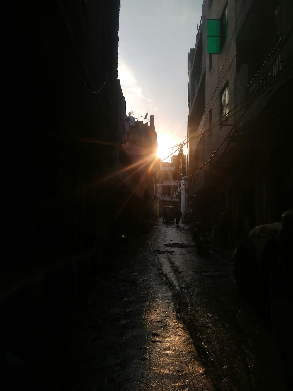 silhouette of person walking on sidewalk during sunset