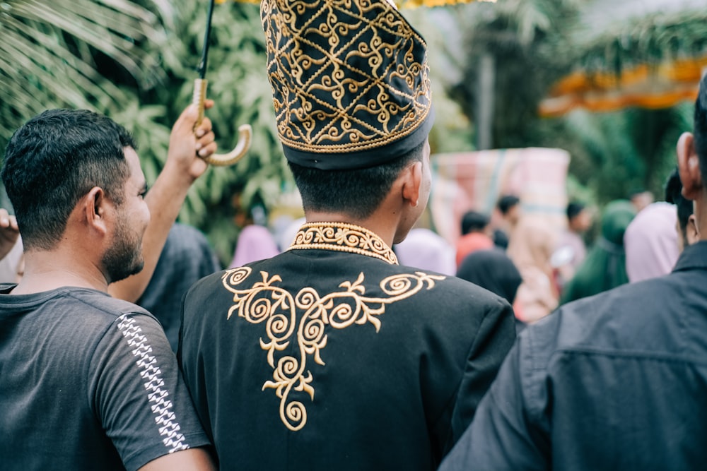 man in black shirt wearing gold crown