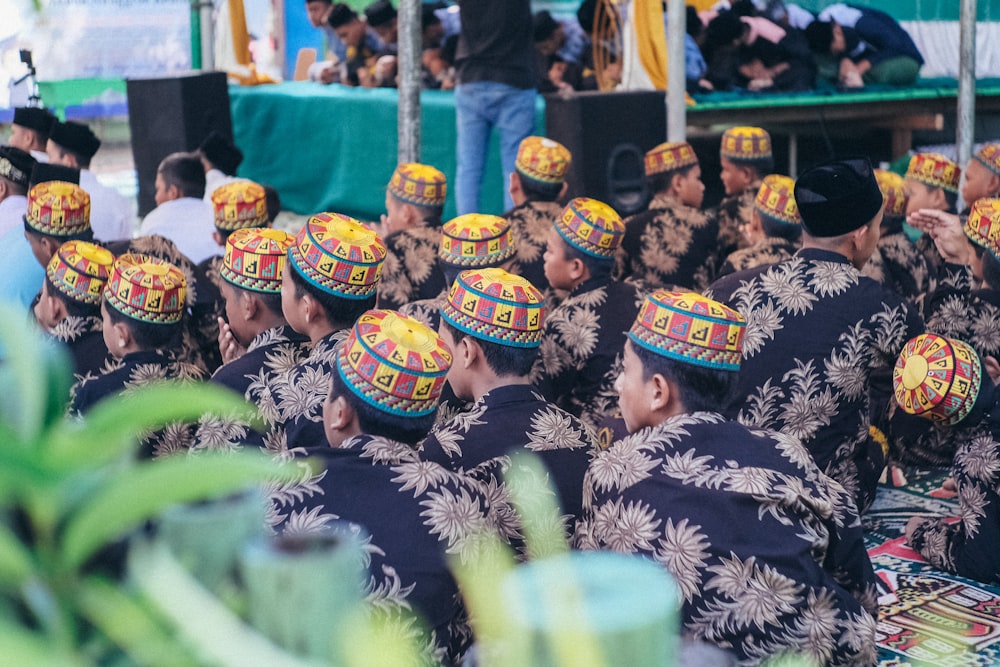 group of people wearing yellow and black hat