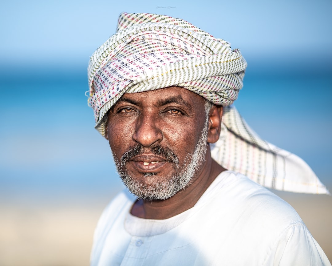 man in white crew neck shirt wearing white and brown hat