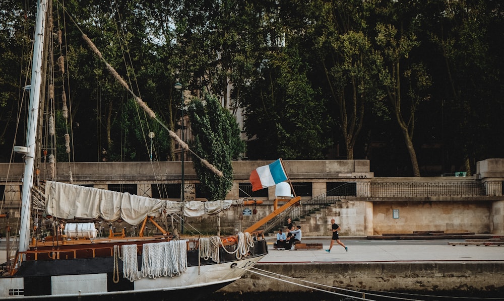 white and brown boat on dock during daytime