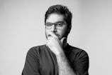 man in black long sleeve shirt wearing black framed eyeglasses
