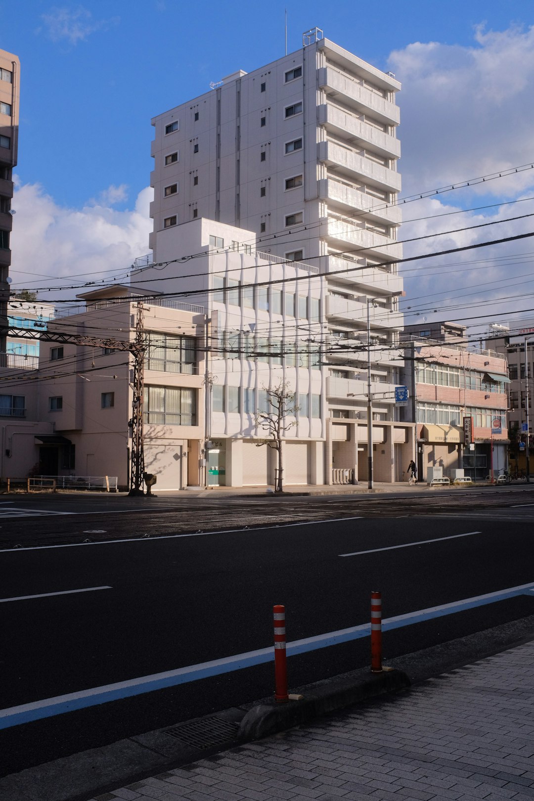 white concrete building beside road during daytime