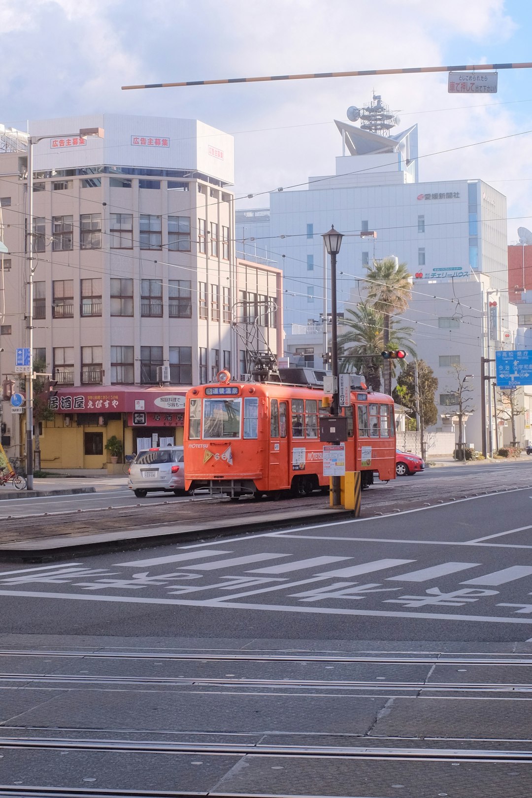 red bus on road near building during daytime