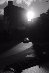 A cinematic still from a dramatic indie film set in downtown Augusta at sunset.