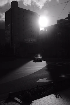 A cinematic still from a dramatic indie film set in downtown Augusta at sunset.