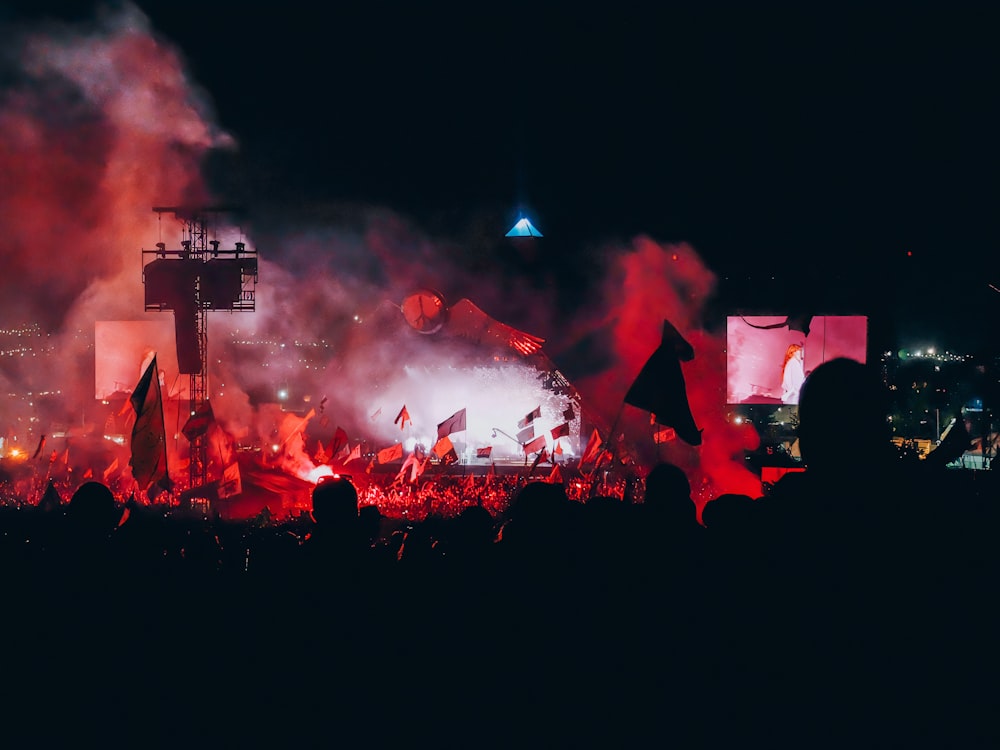 people watching fireworks display during nighttime