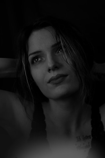 Portrait photograph of the deceased person with a respectful and gentle background.