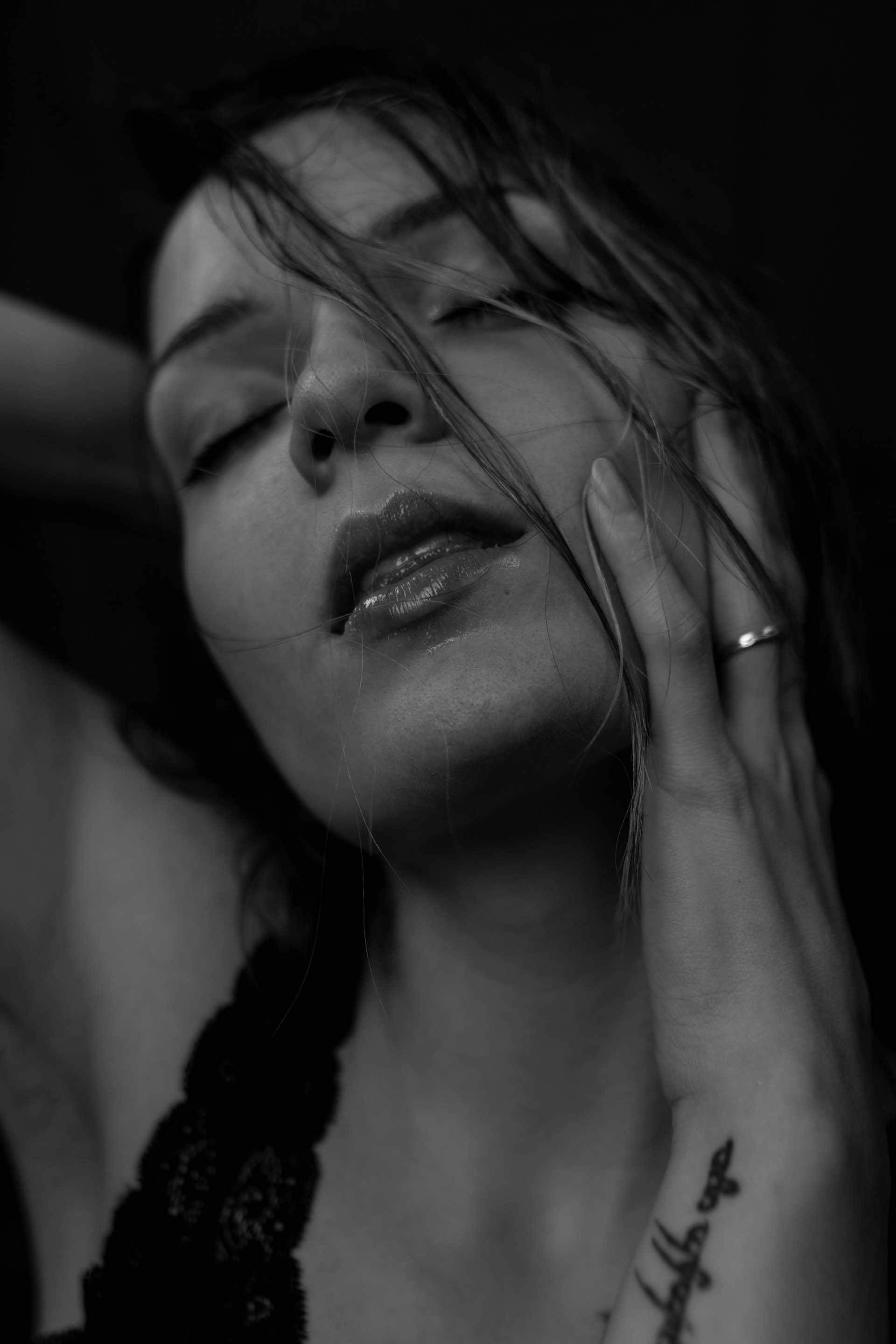 grayscale photo of woman with her eyes closed