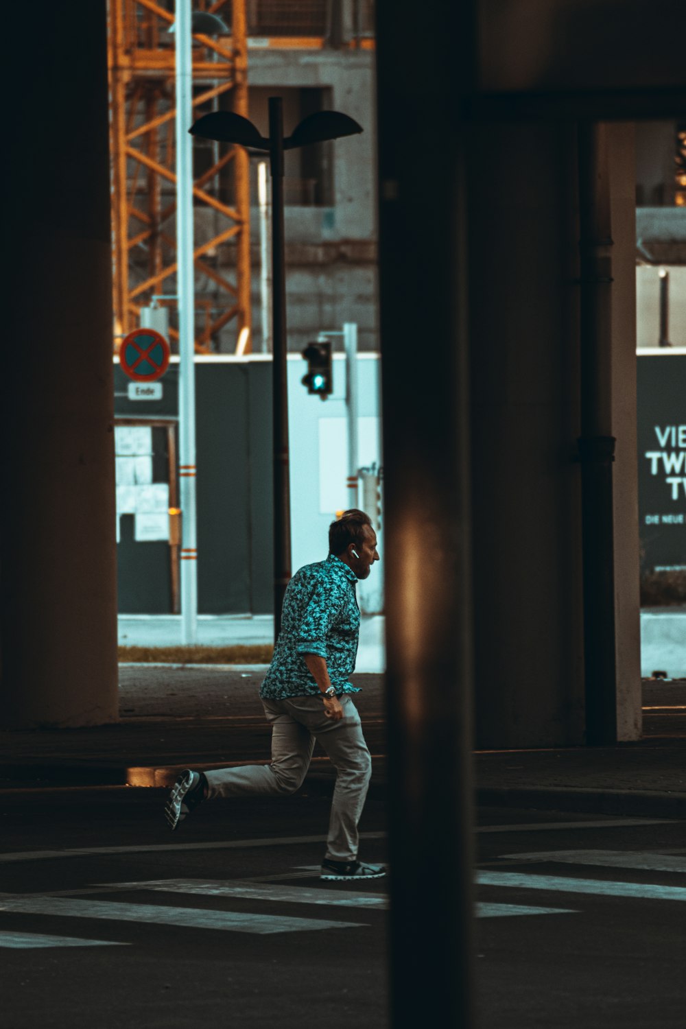 man in blue and white dress shirt and white pants sitting on brown wooden bench