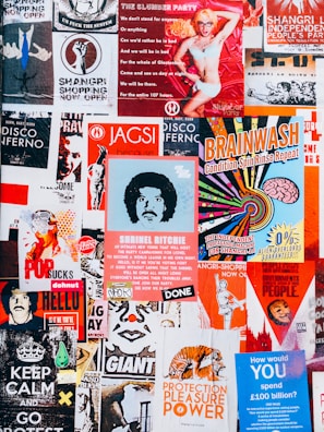A vibrant collage of posters with various colors and designs. The posters feature a mix of artistic illustrations, bold typography, and playful graphics. There are themes of independence, entertainment, and political statements with a retro vibe.