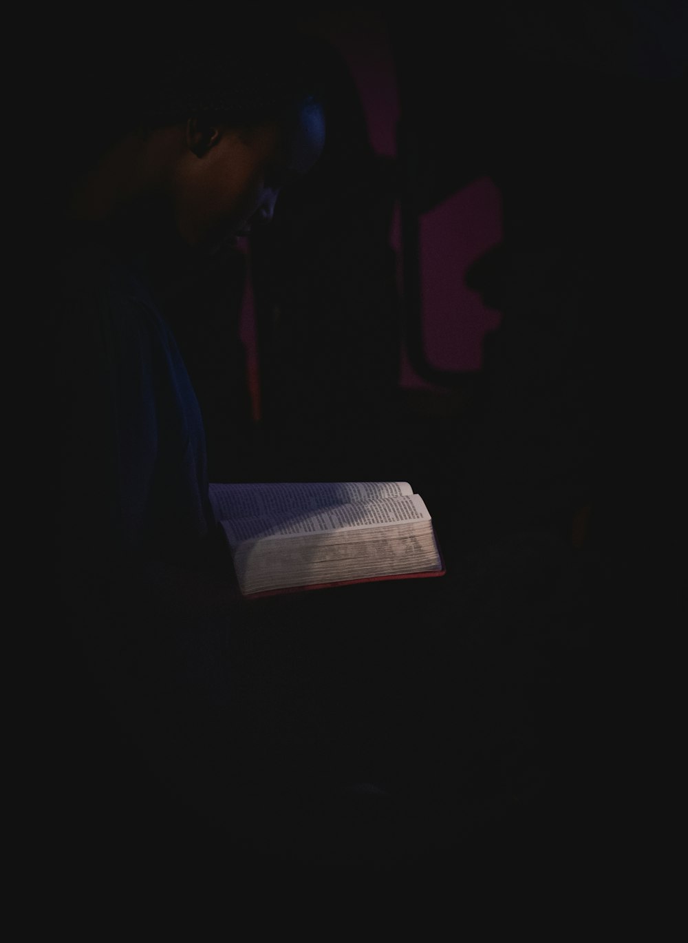 man in black shirt holding white paper