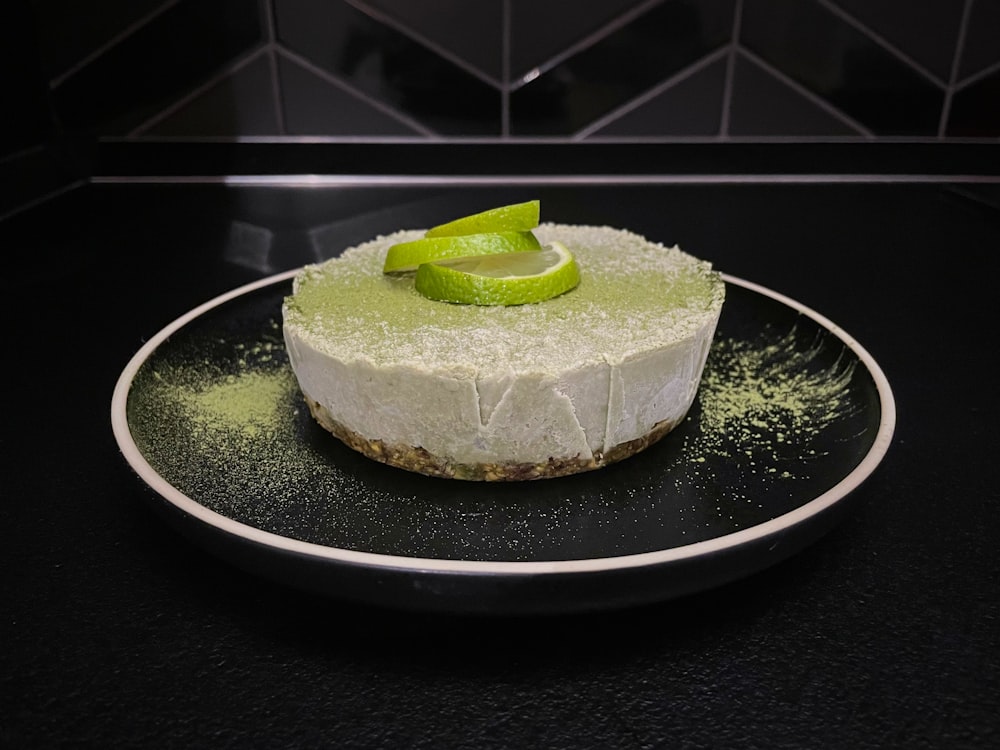 green and white cake on black ceramic plate