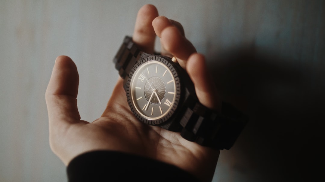 black and silver round analog watch