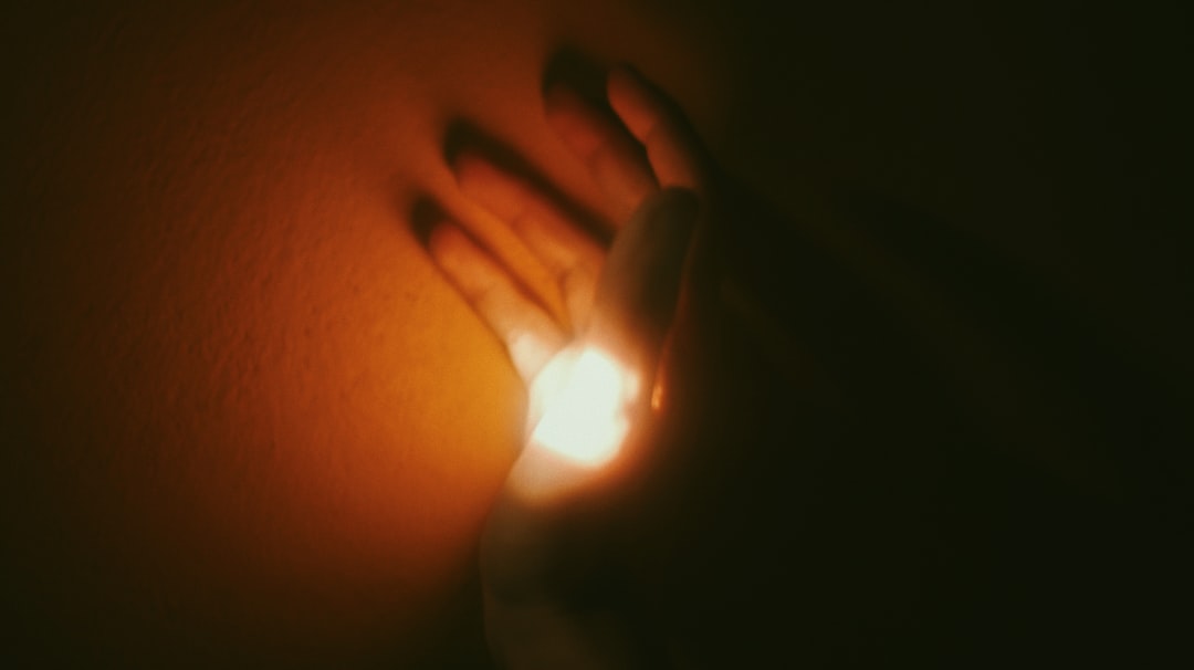 persons hand on light