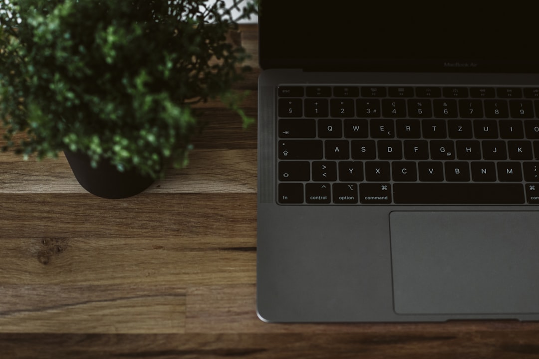 macbook pro on brown wooden table