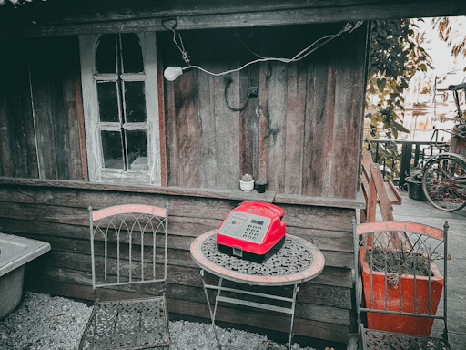 Rustic wooden table with fresh artisanal food products and a vintage telephone.