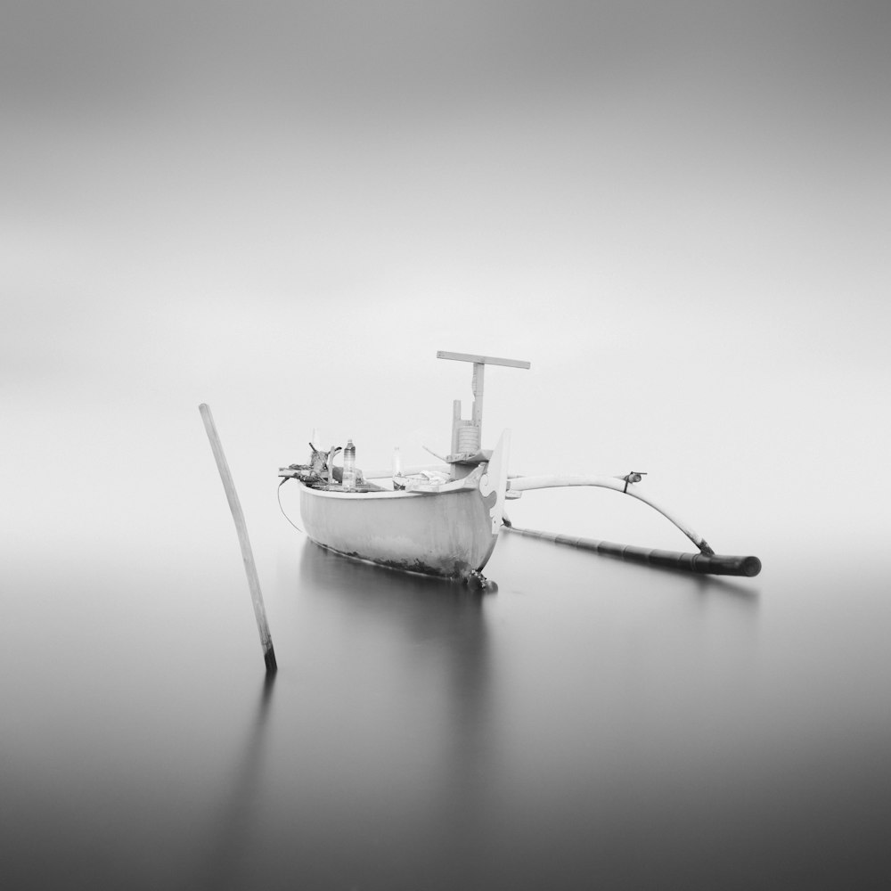 grayscale photo of boat on water