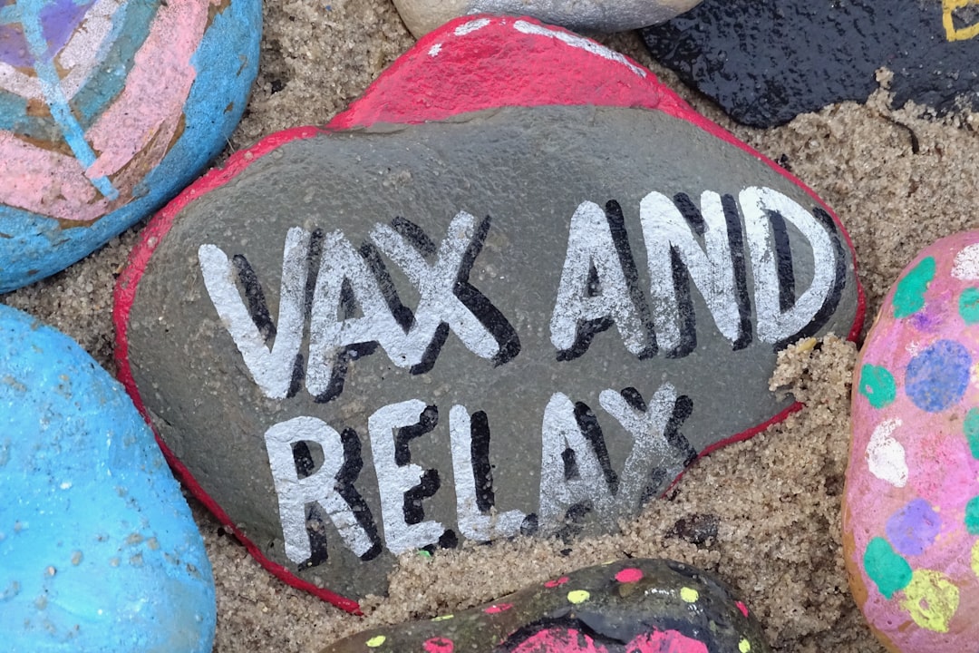 text, A painted stone with the message Vax and Relax. Hope in the vaccine and in time life returns to normal.
