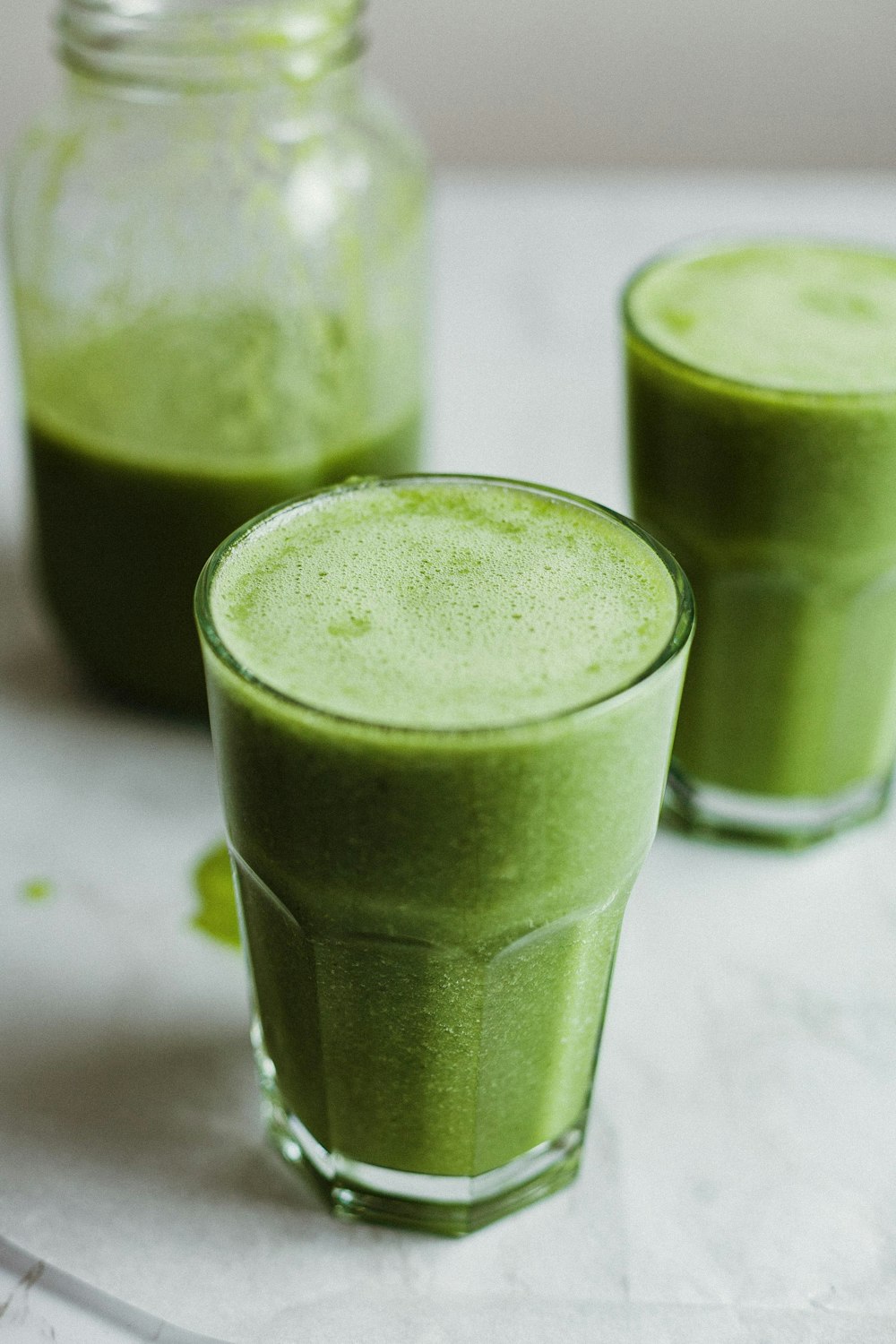 green liquid in clear drinking glass