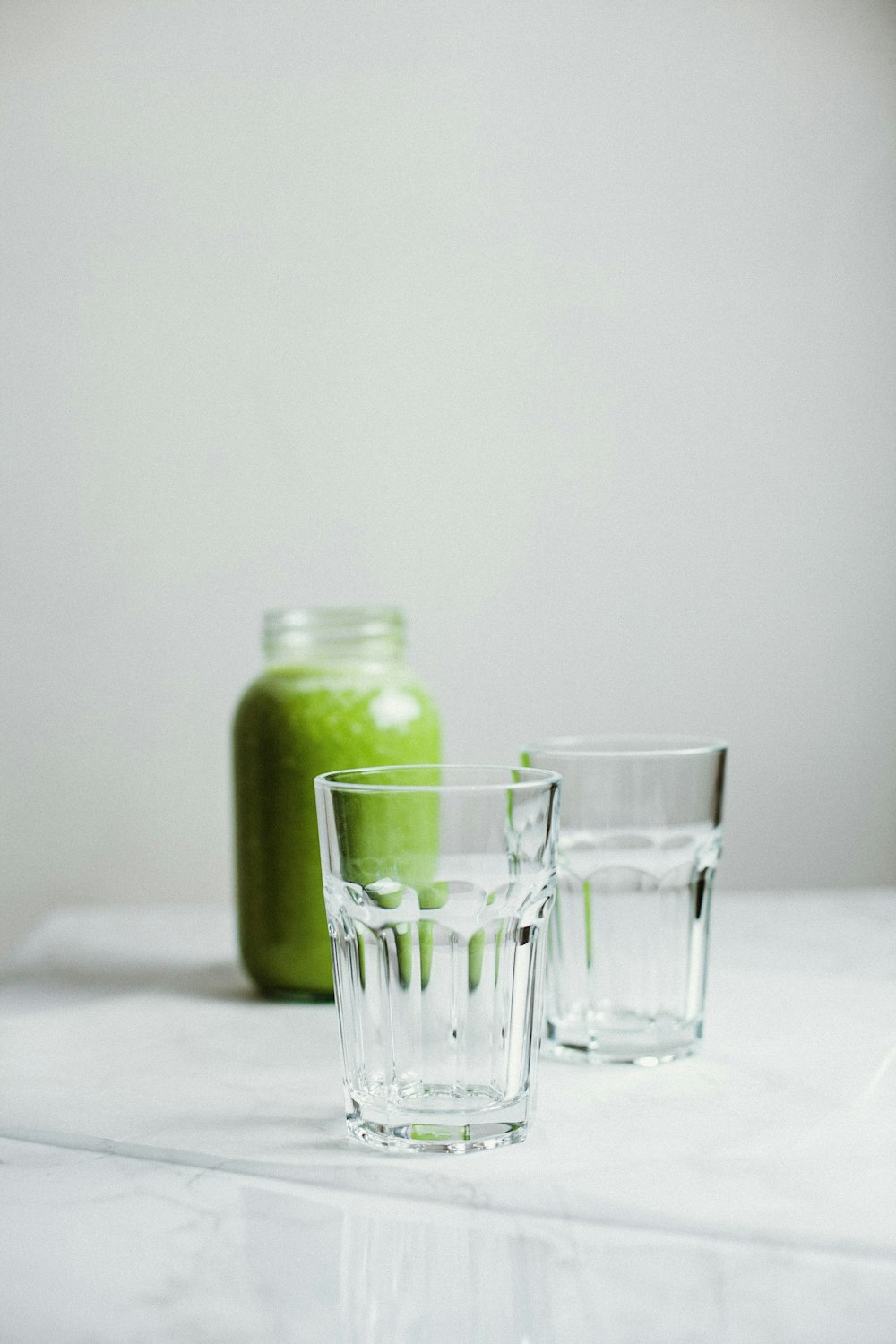 green fruit in clear glass jar
