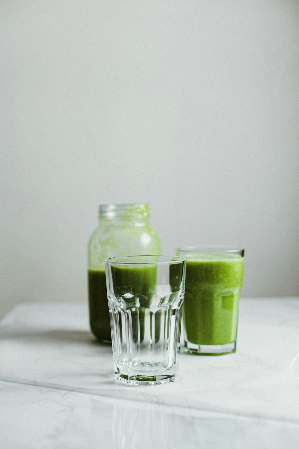 clear glass jar with green liquid