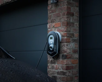 A modern electric car charging at a home station