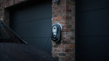 Electrician installing a modern electric vehicle charging station at a residential home