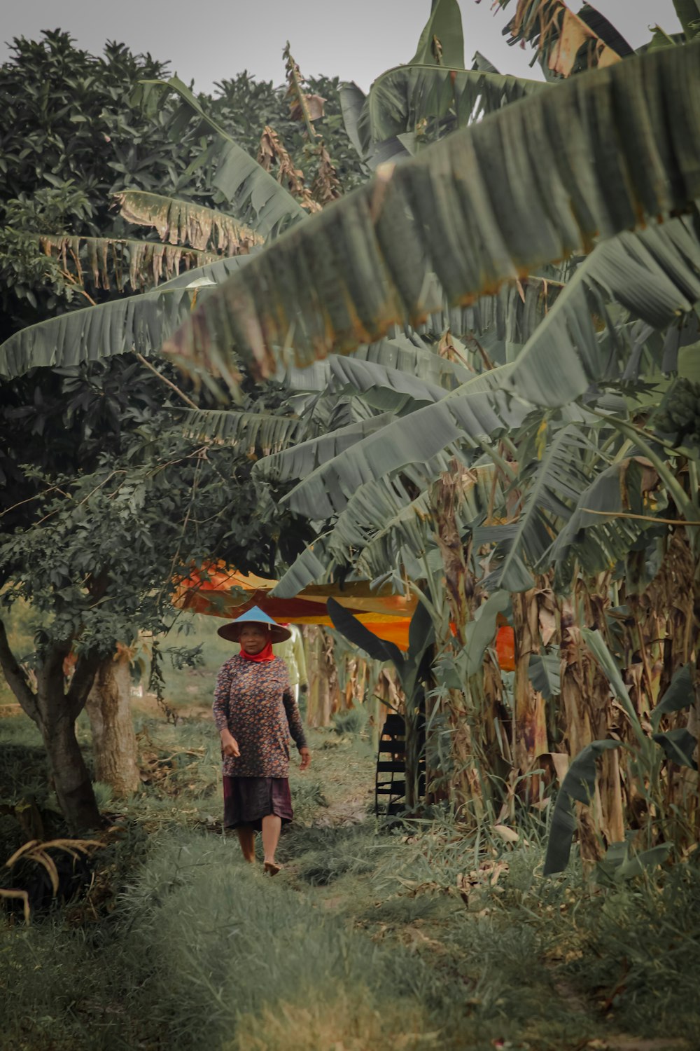 woman in red and white dress holding yellow umbrella