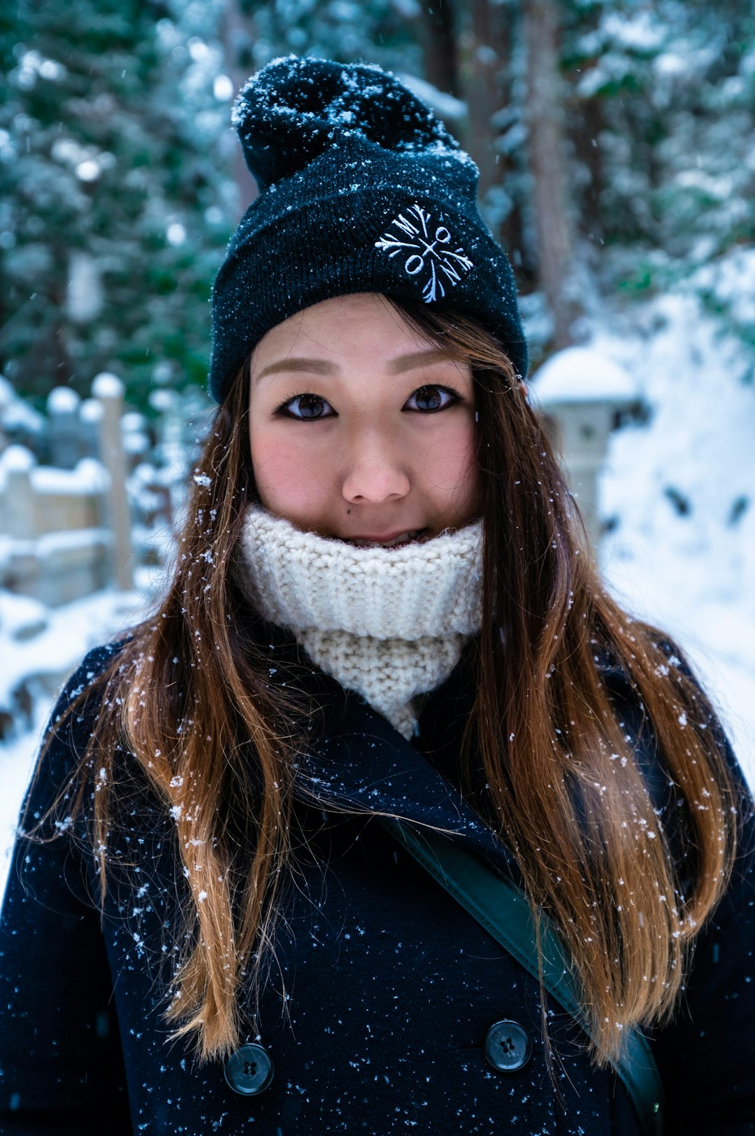 woman in black knit cap and blue jacket