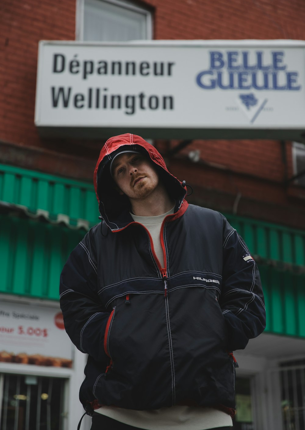 man in black zip up jacket and red knit cap