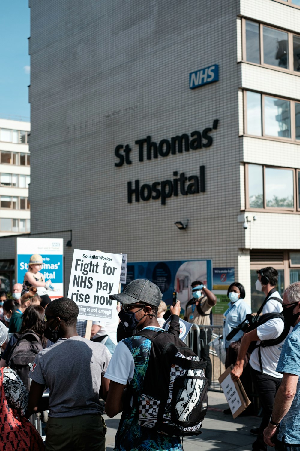 people standing in front of white and blue building during daytime