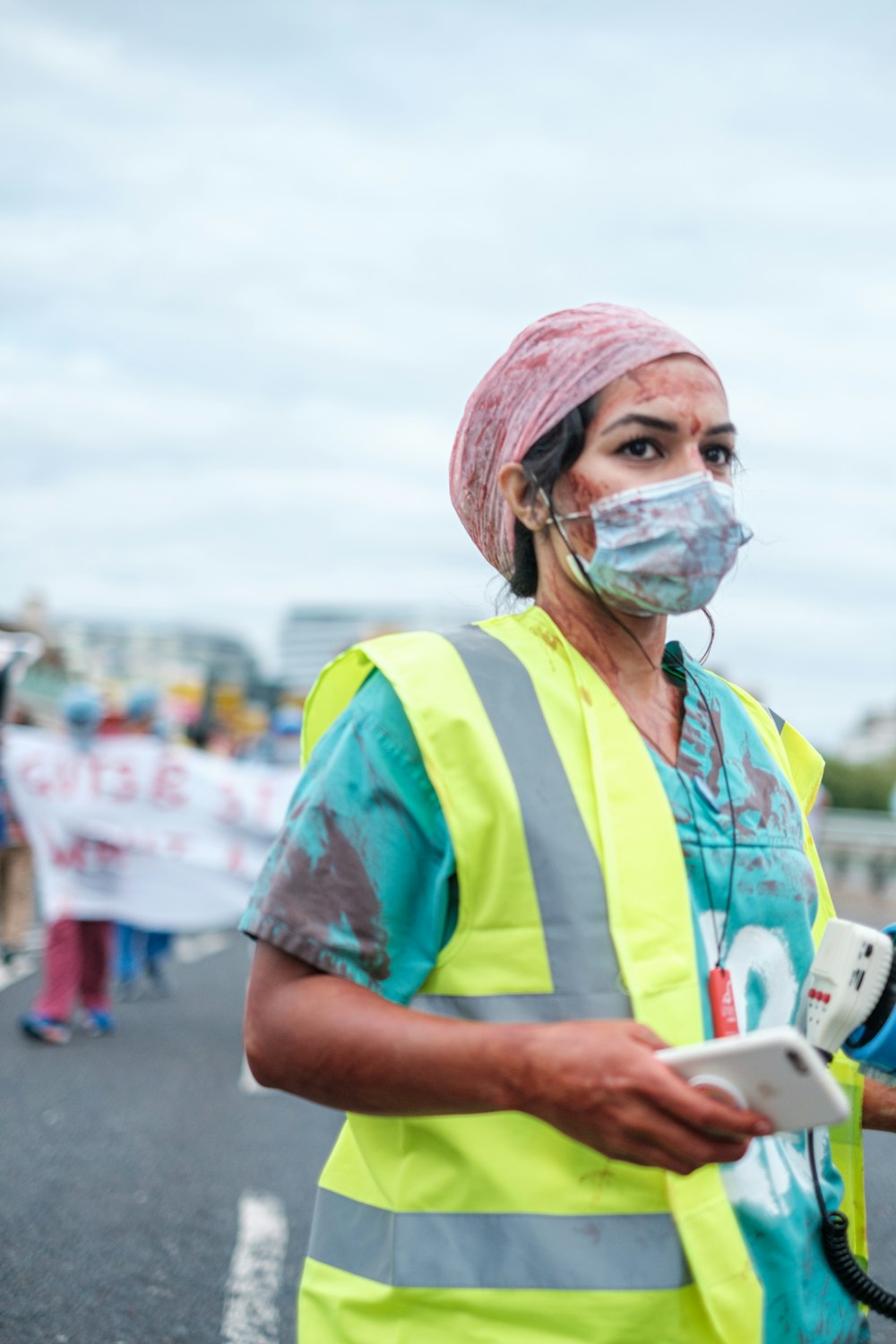 woman in blue green and yellow shirt wearing face mask