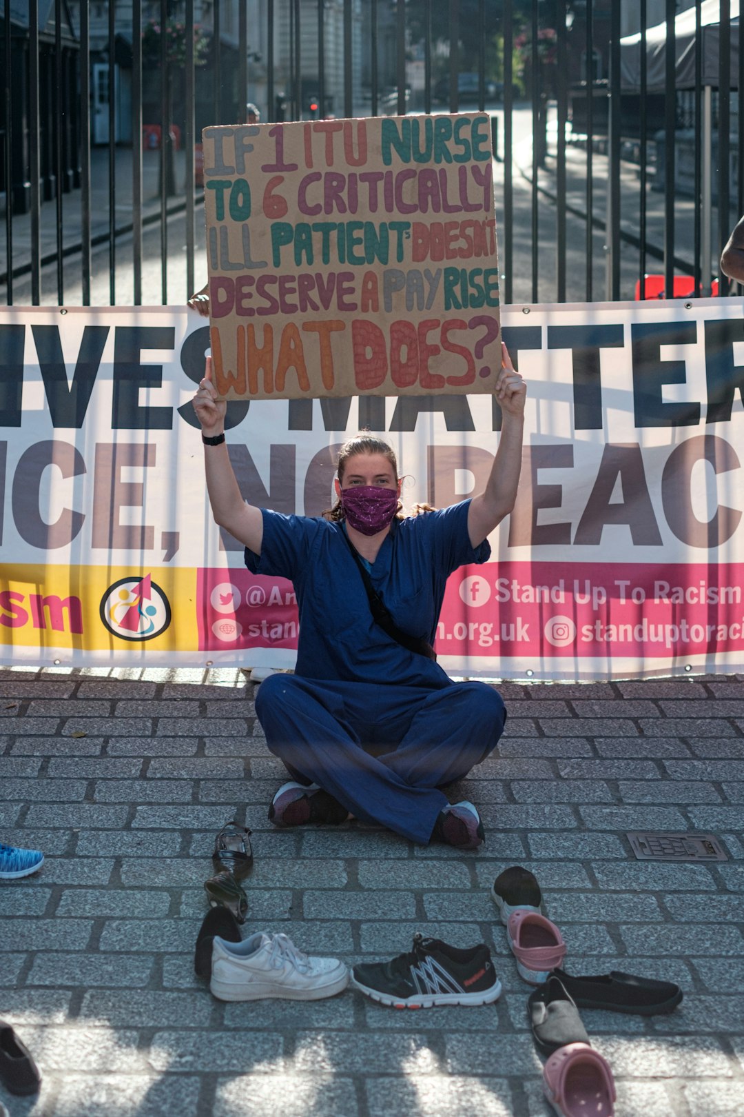 man in black shirt and pants sitting on pavement