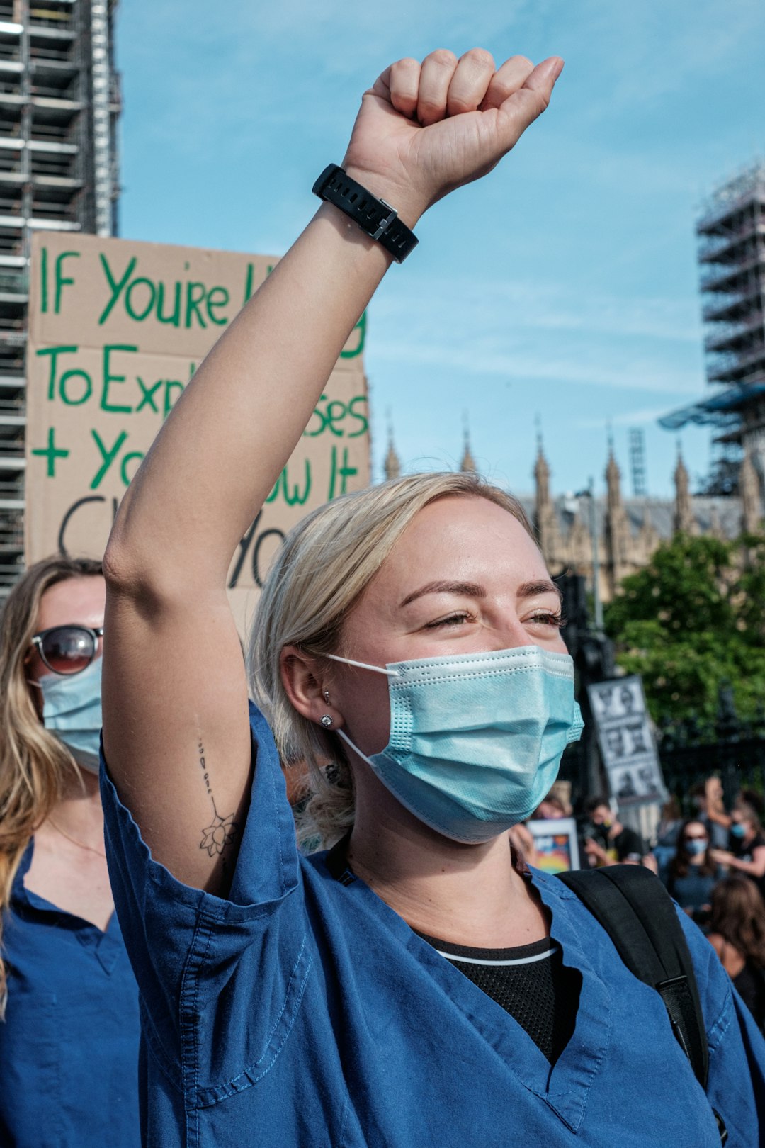 woman in blue shirt wearing white mask