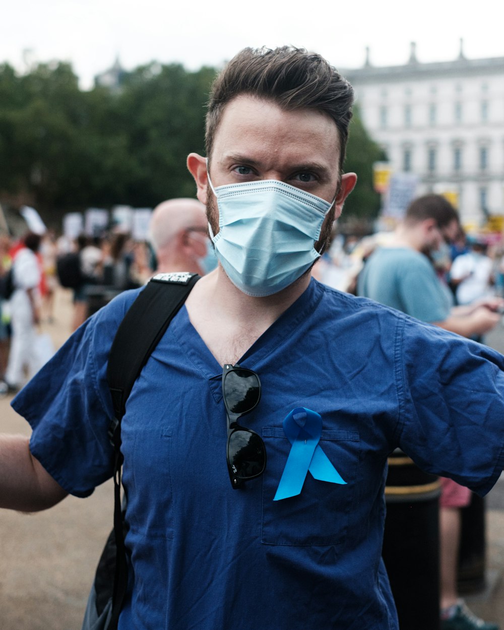 boy in blue polo shirt wearing white face mask