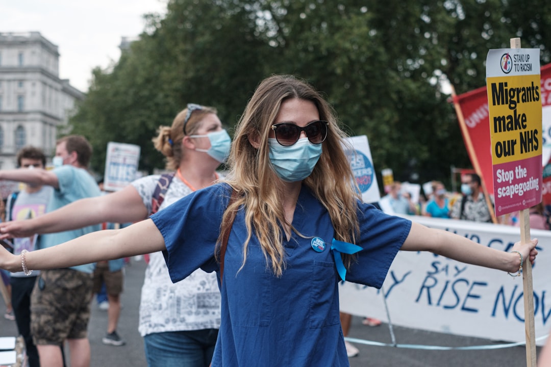 woman in blue dress wearing black sunglasses