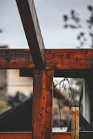Close-up of handcrafted wood details on a modular gazebo’s corner post, highlighting natural textures.