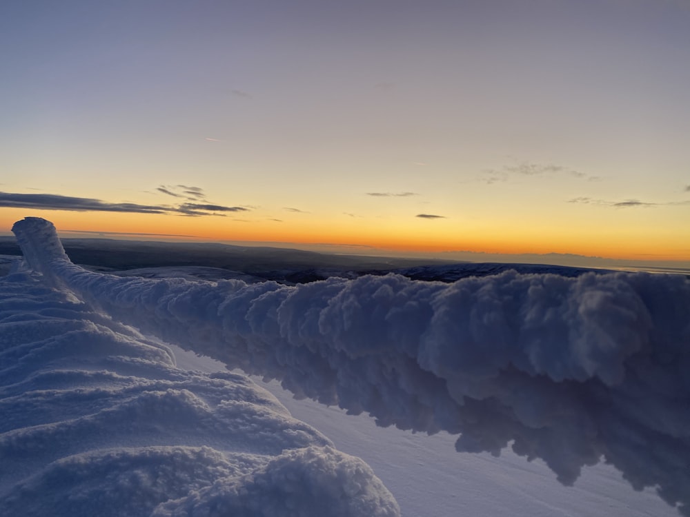 snow covered ground during sunset