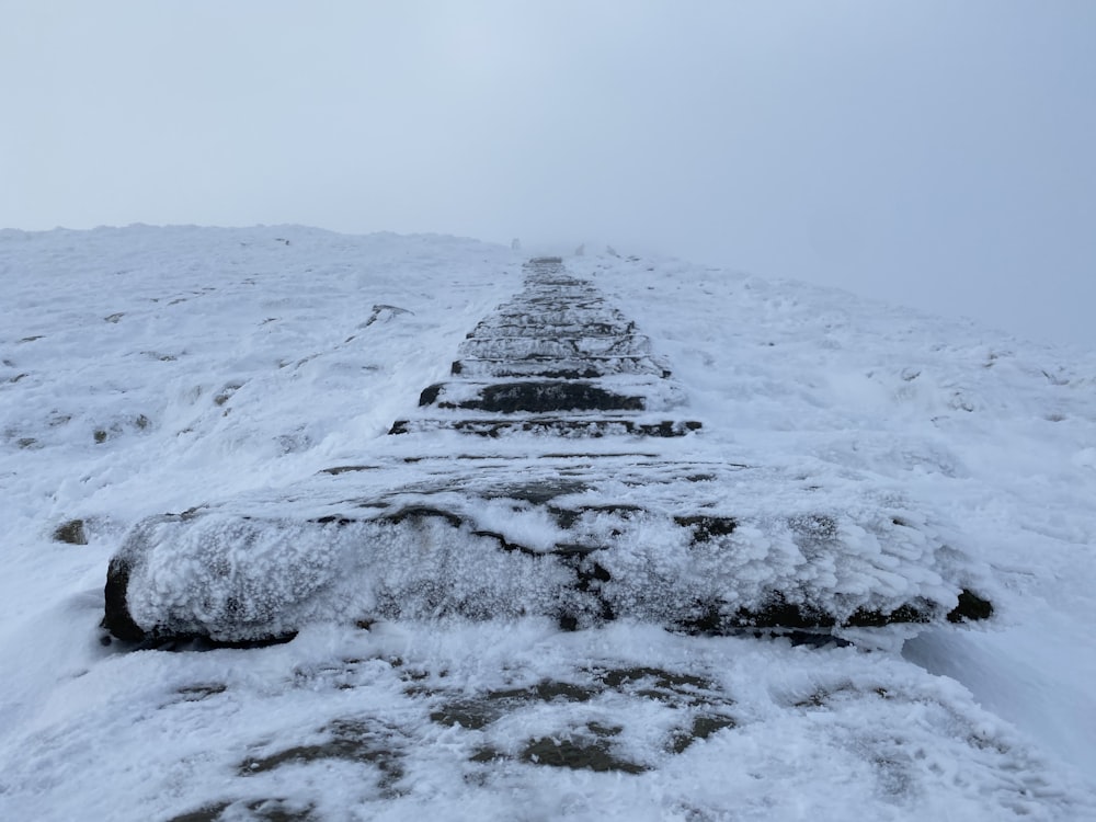 gray rock formation covered by snow