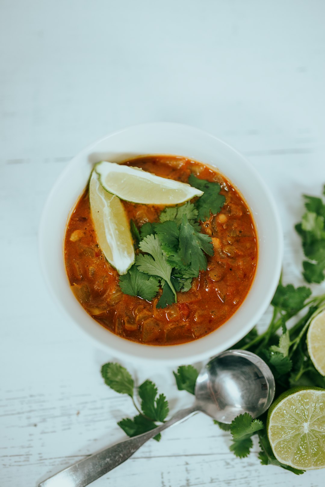 soup with green leaf on white ceramic bowl