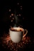 white ceramic teacup with coffee beans