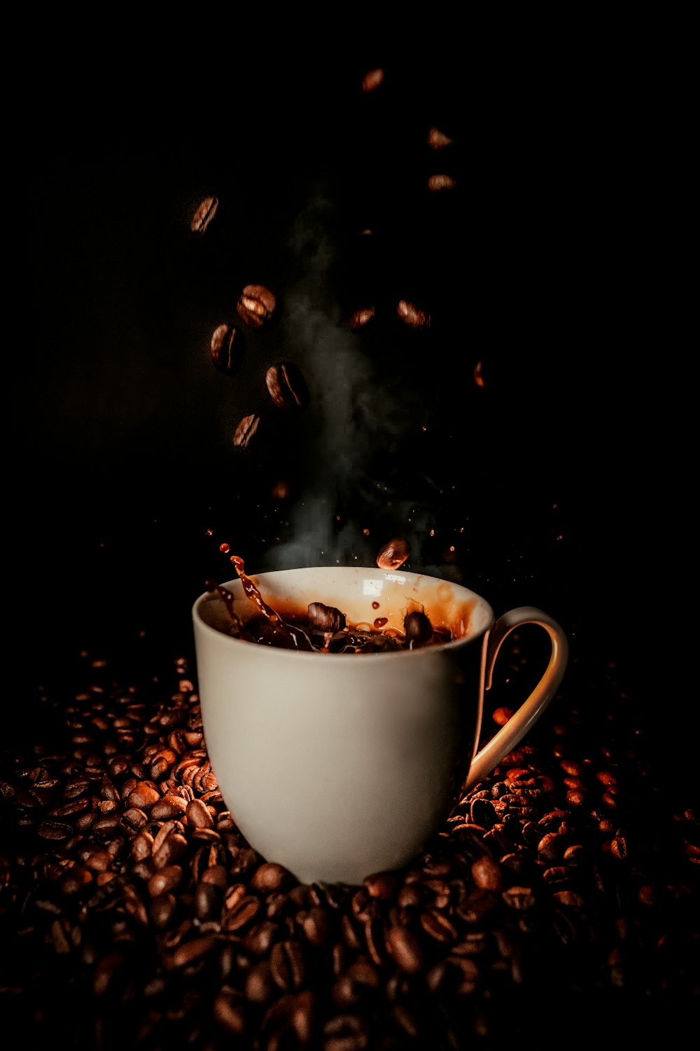 white ceramic teacup with coffee beans