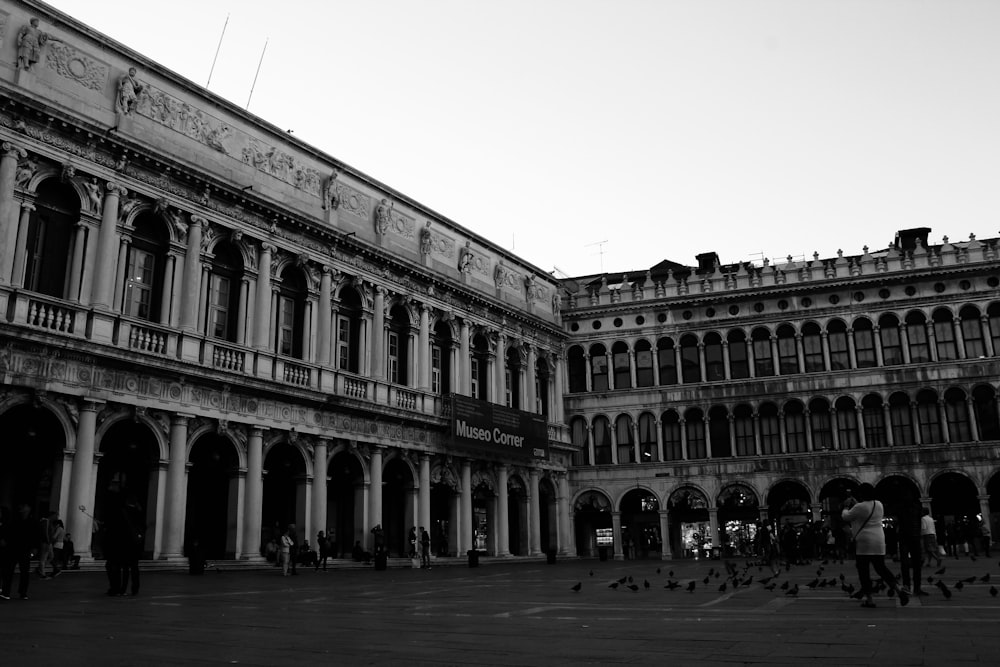 grayscale photo of building near body of water