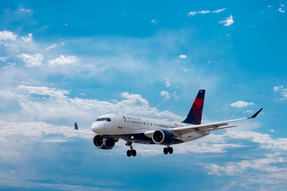 white passenger plane under blue sky during daytime